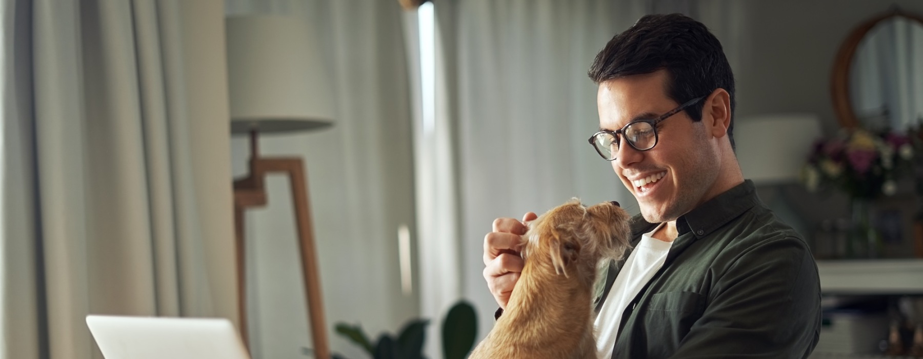 a man with his dog at a computer